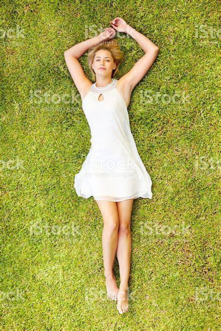 a woman laying on top of a bed next to a man